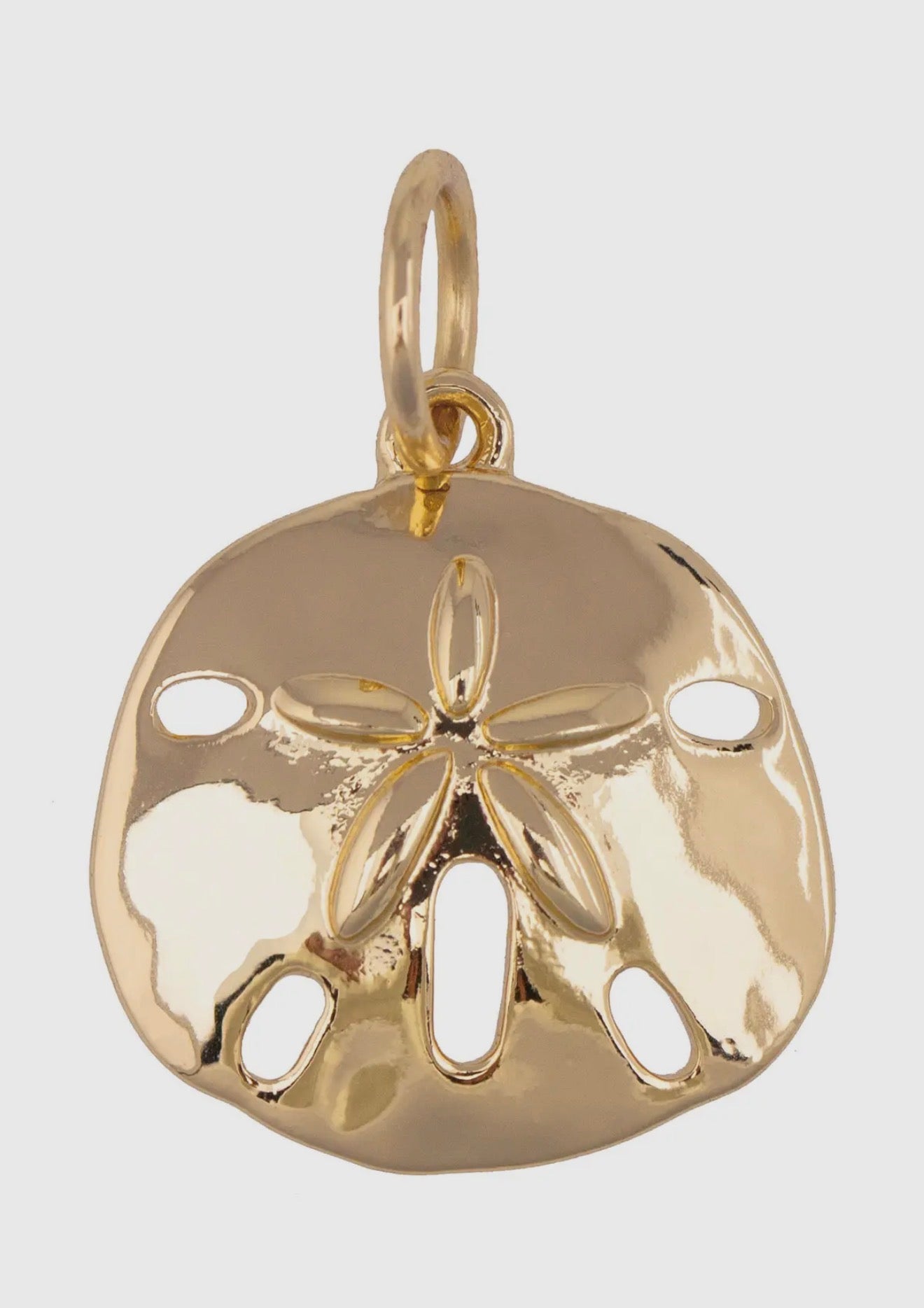 Sand dollar charm in shiny gold